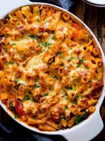 square image of vegetable pasta bake in a white dish