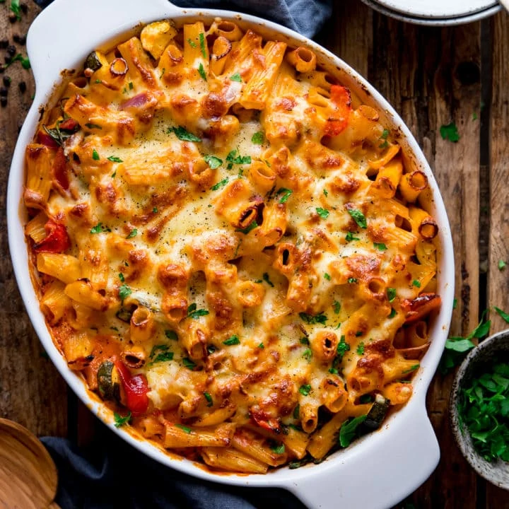 square image of vegetable pasta bake in a white dish