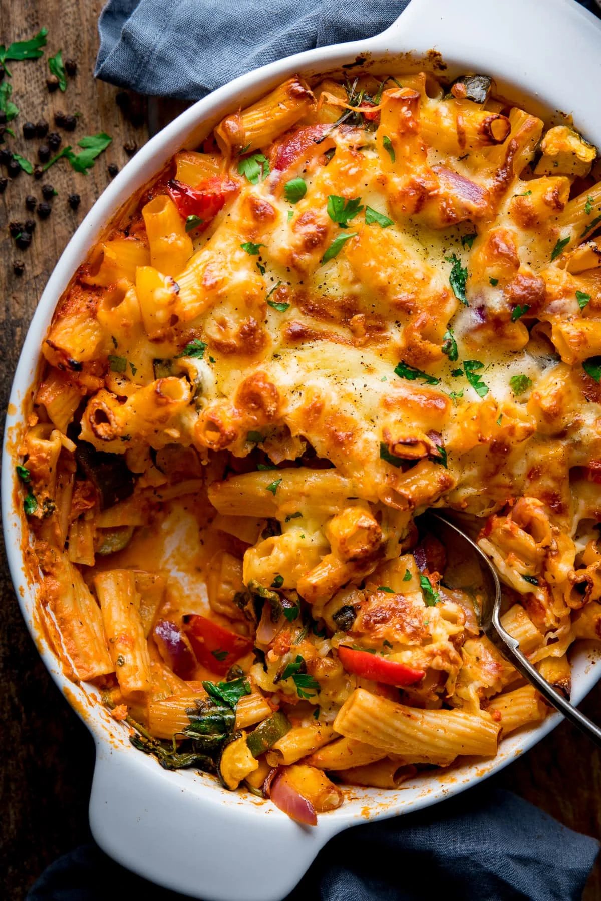 Overhead image of vegetable pasta bake with a spoonful taken out