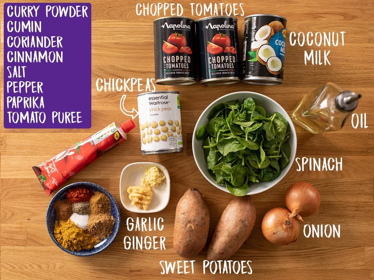 Ingredients for chickpea and sweet potato curry on a wooden table