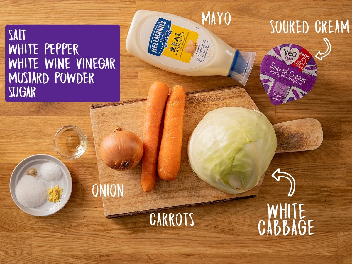 Ingredients for making creamy coleslaw in a wooden table