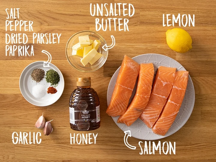 Ingredients for honey garlic baked salmon on a wooden table