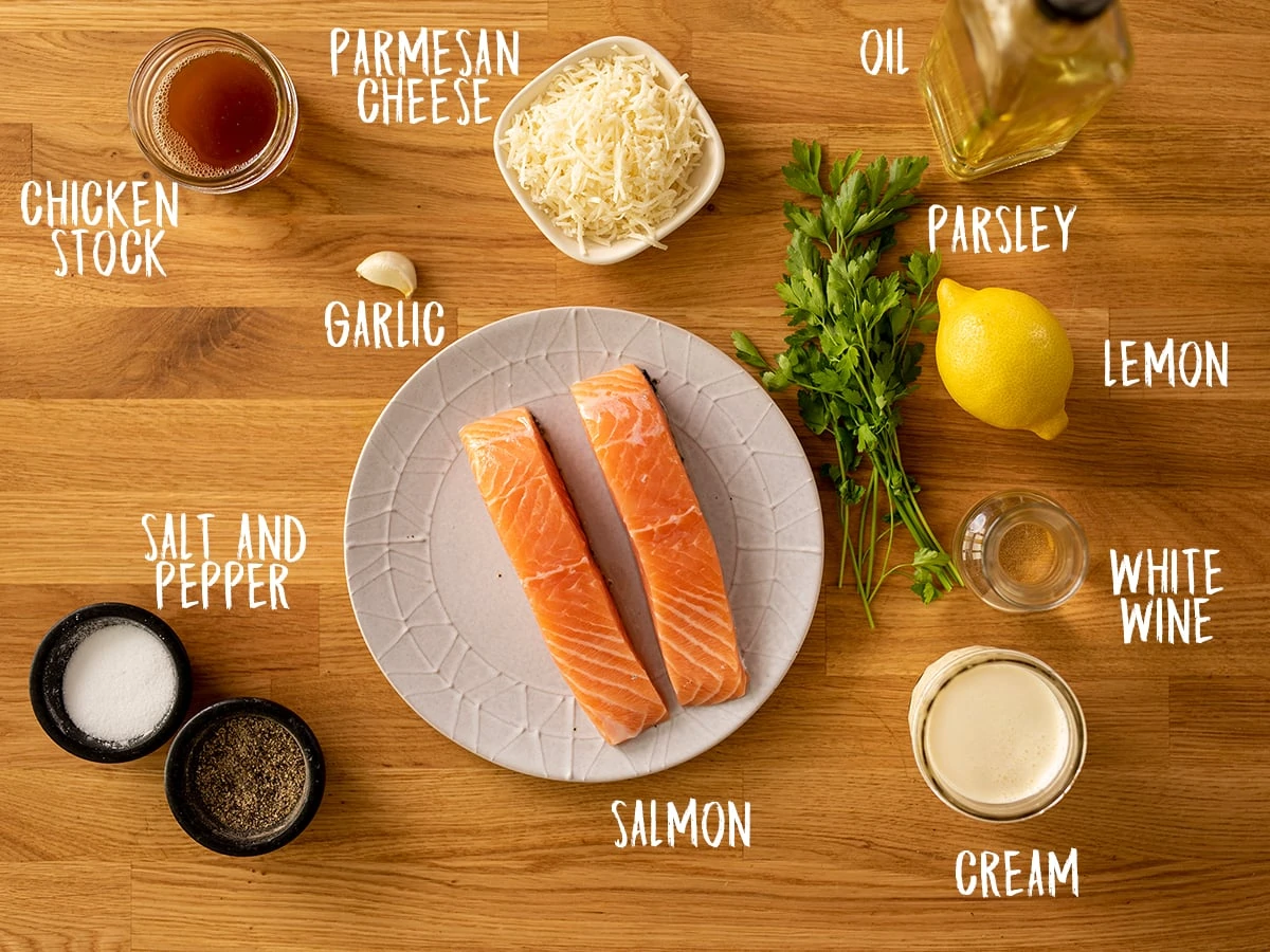 Ingredients for salmon with creamy white wine sauce on a wooden table