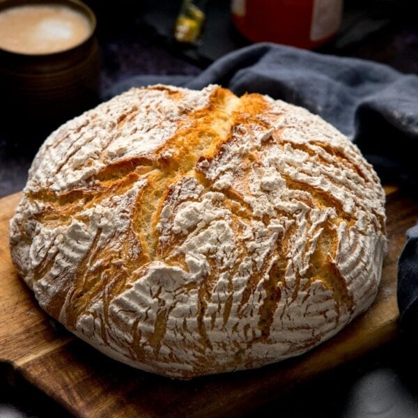 Square image of a round loaf of bread on a wooden board