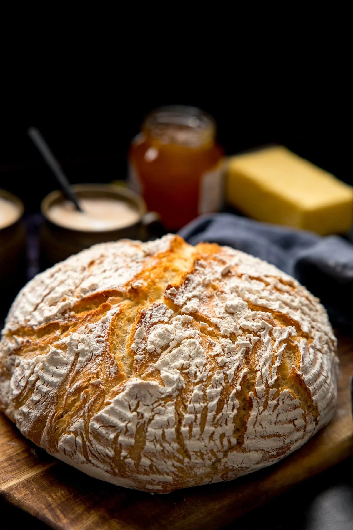 Artisan bread on a wooden board against a dark background