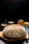 Round loaf of artisan bread on a wooden board