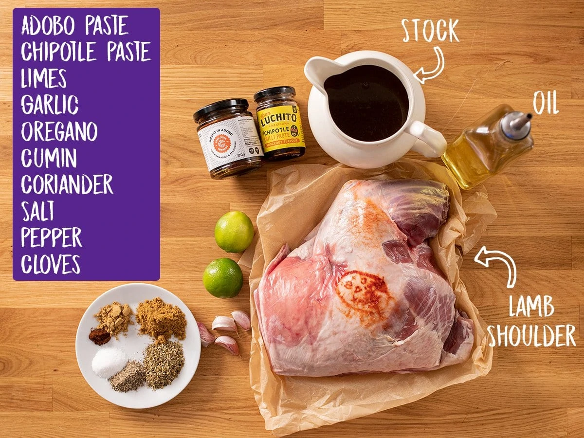 Ingredients for lamb barbacoa on a wooden table