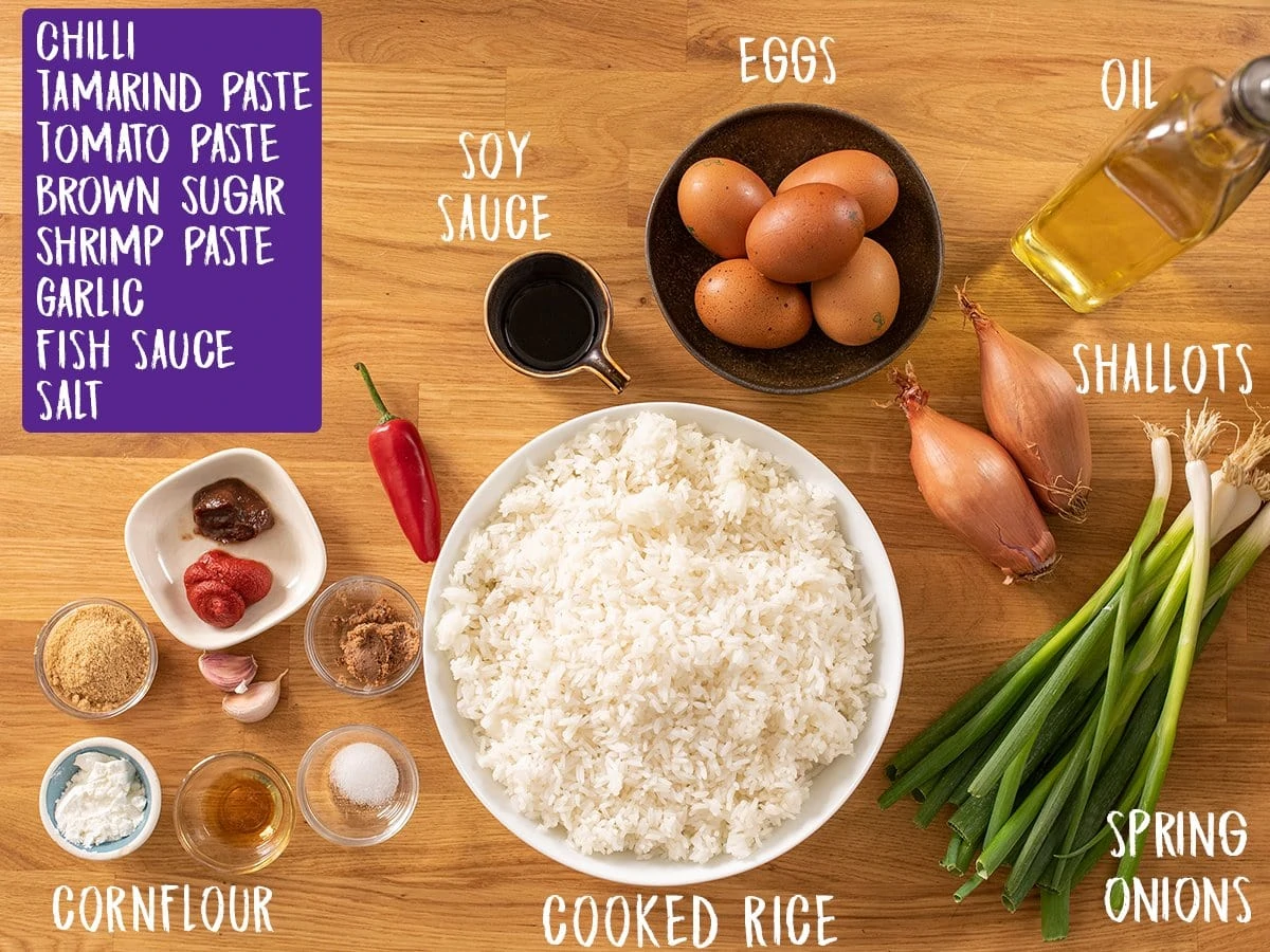 Ingredients for nasi goreng on a wooden table