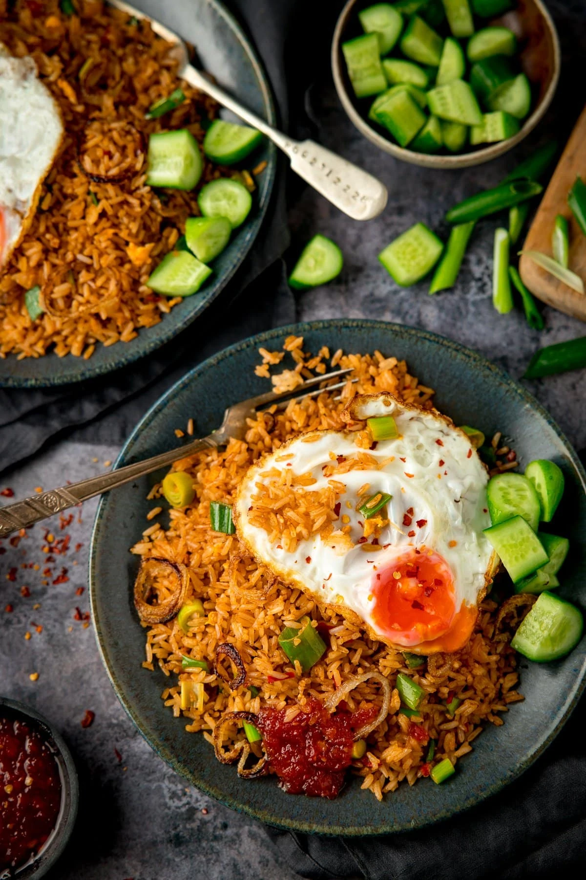Overhead image of nasi goreng rice on a plate, topped with a fried egg