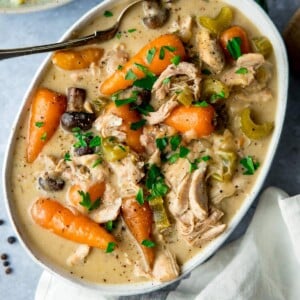 White oblong serving bowl filled with chicken casserole