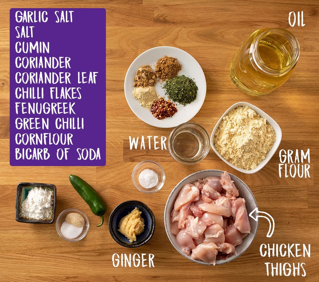 Ingredients for chicken pakora on a wooden table