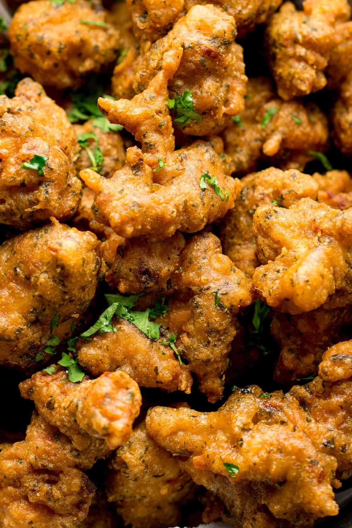 Close up of chicken pakoras scattered with coriander