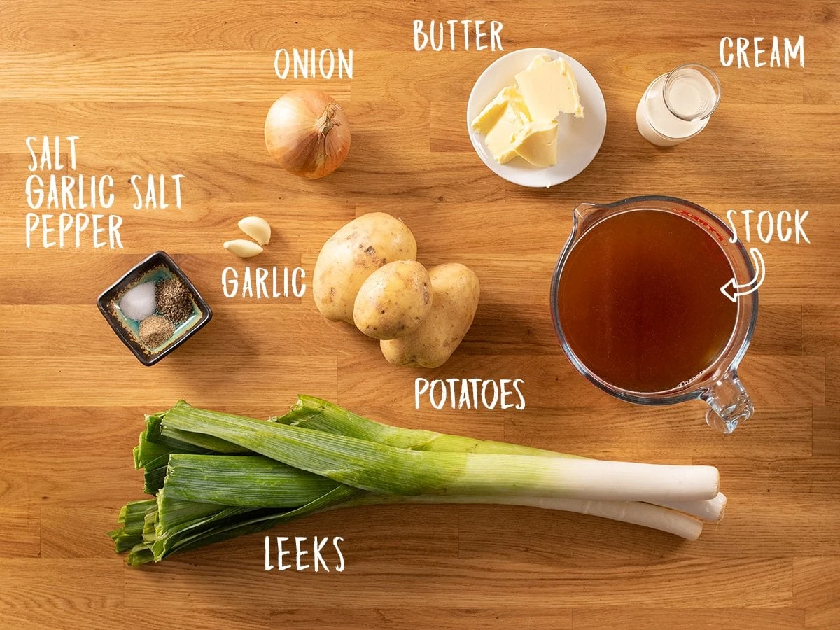 Ingredients for leek and potato soup on a wooden table