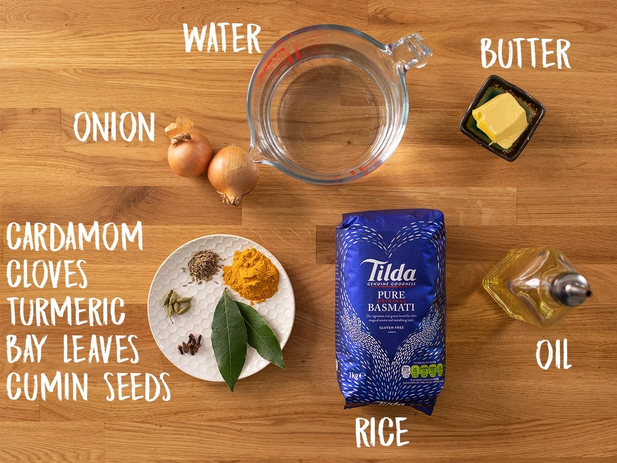 Ingredients for Pilau rice on a wooden table