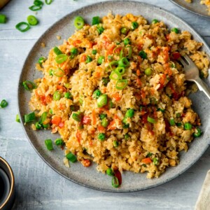 Cauliflower fried rice on a grey plate on a light background