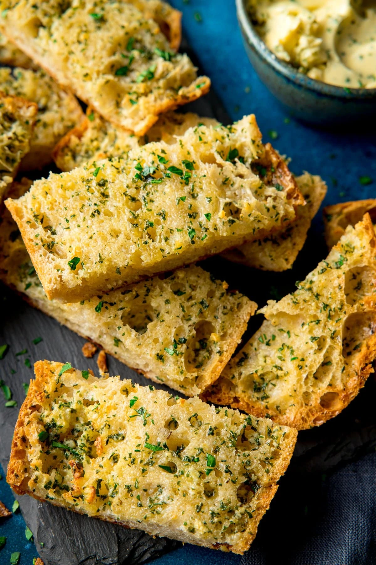 Slices of garlic bread on a piece of slate