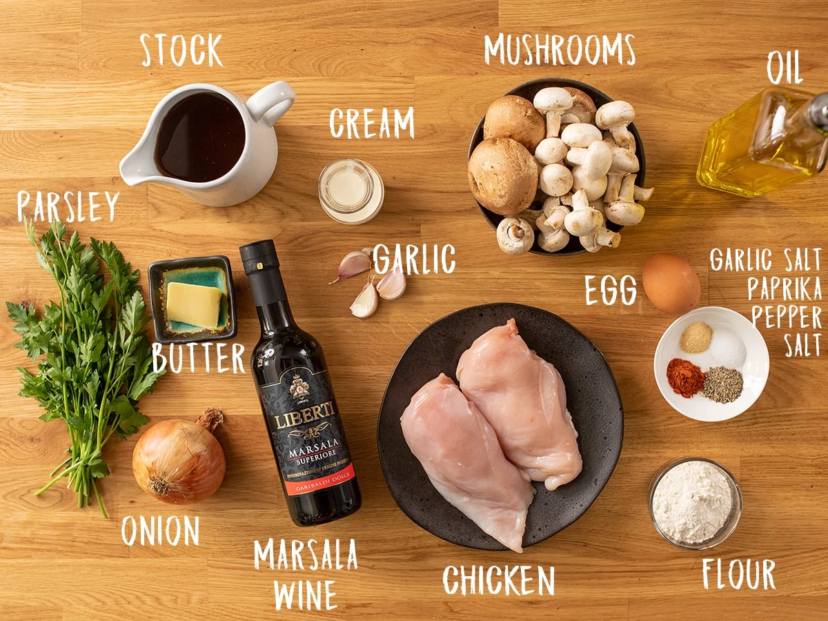 Ingredients for chicken marsala on a wooden table