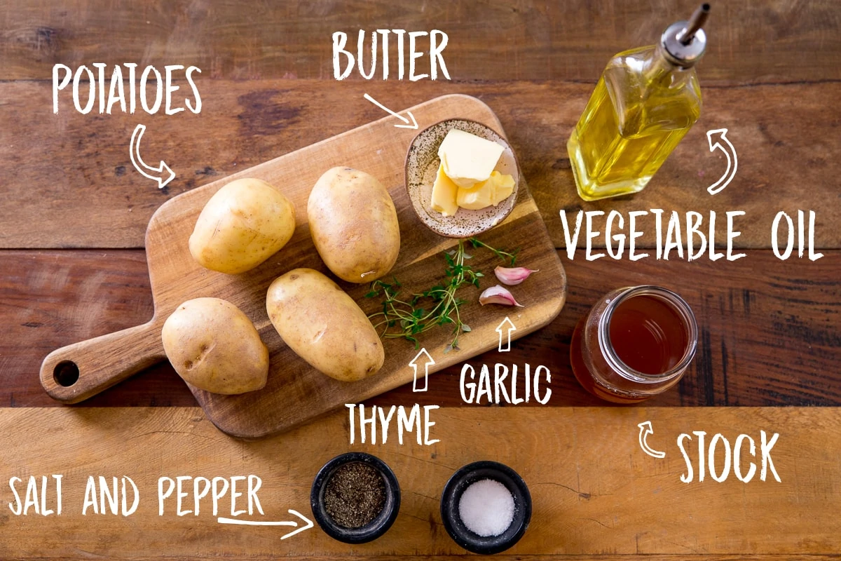 Ingredients for fondant potatoes on a wooden table