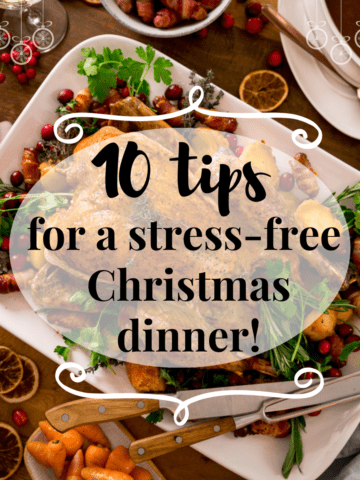 Square Infographic showing text for 10 tips for a stress-free Christmas dinner on the background of a Christmas dinner table filled with food.