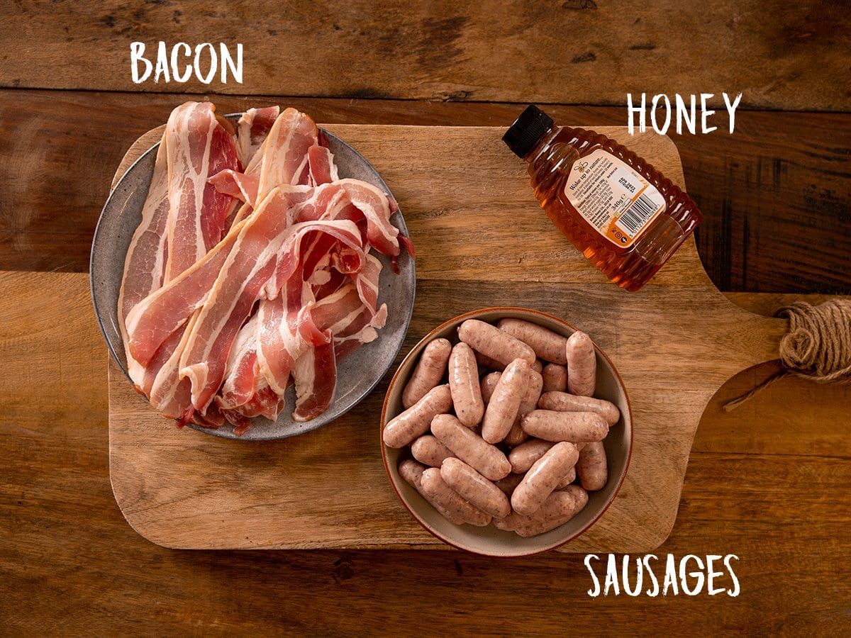 Ingredients for pigs in blankets on a wooden table