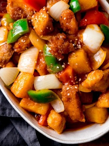 Overhead of Sweet and sour turkey with peppers and onions in a white oval bowl