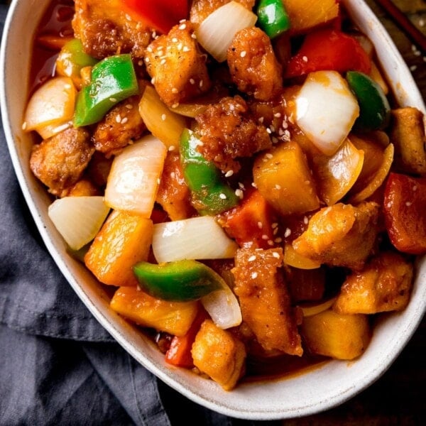 Overhead of Sweet and sour turkey with peppers and onions in a white oval bowl