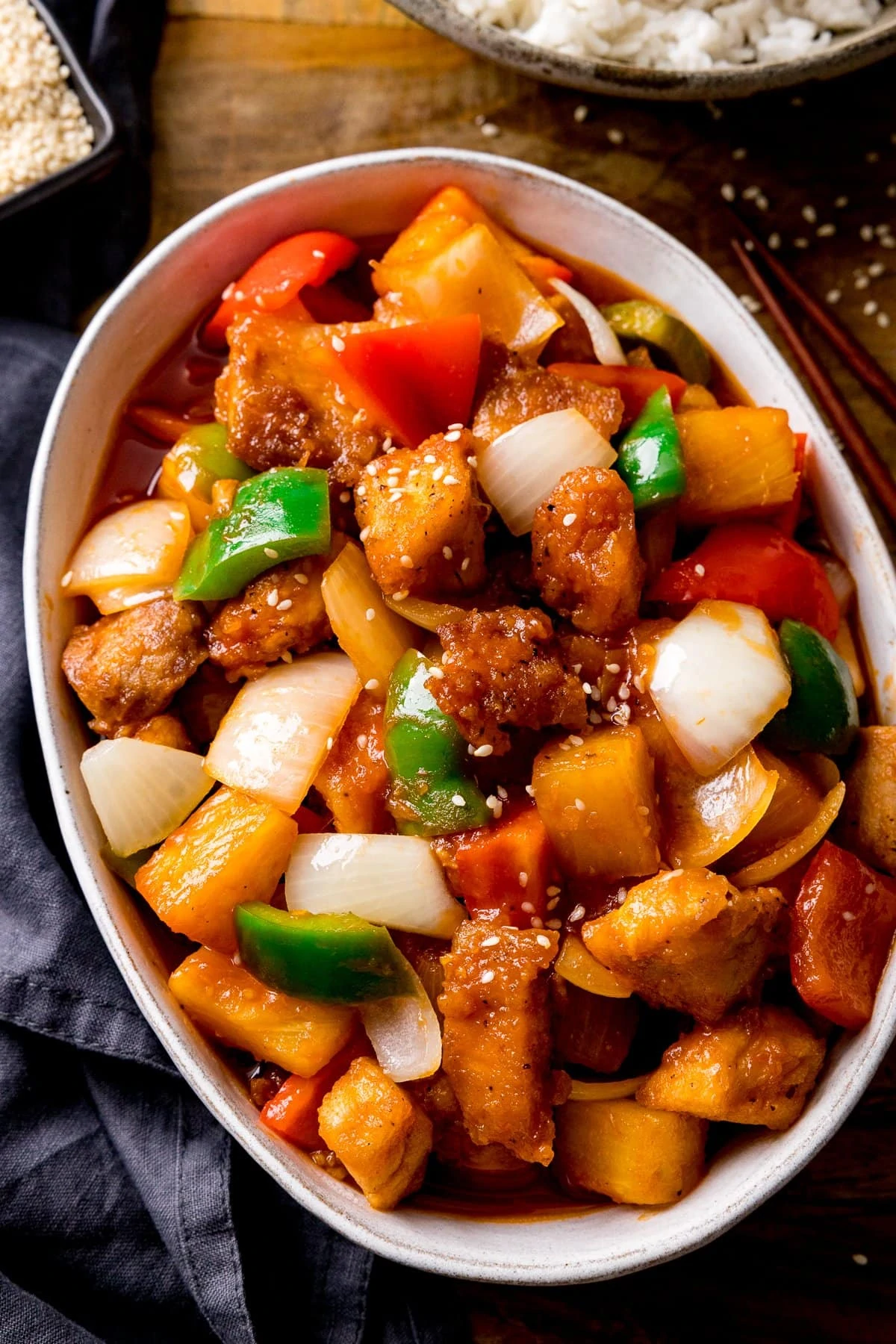 Sweet and sour turkey in a white bowl on a wooden table