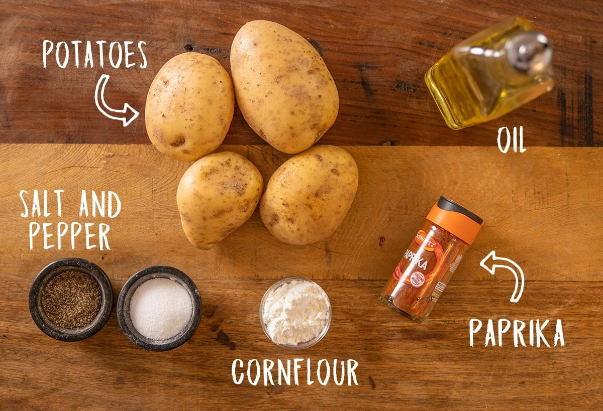 Ingredients for baked oven fries on a wooden background