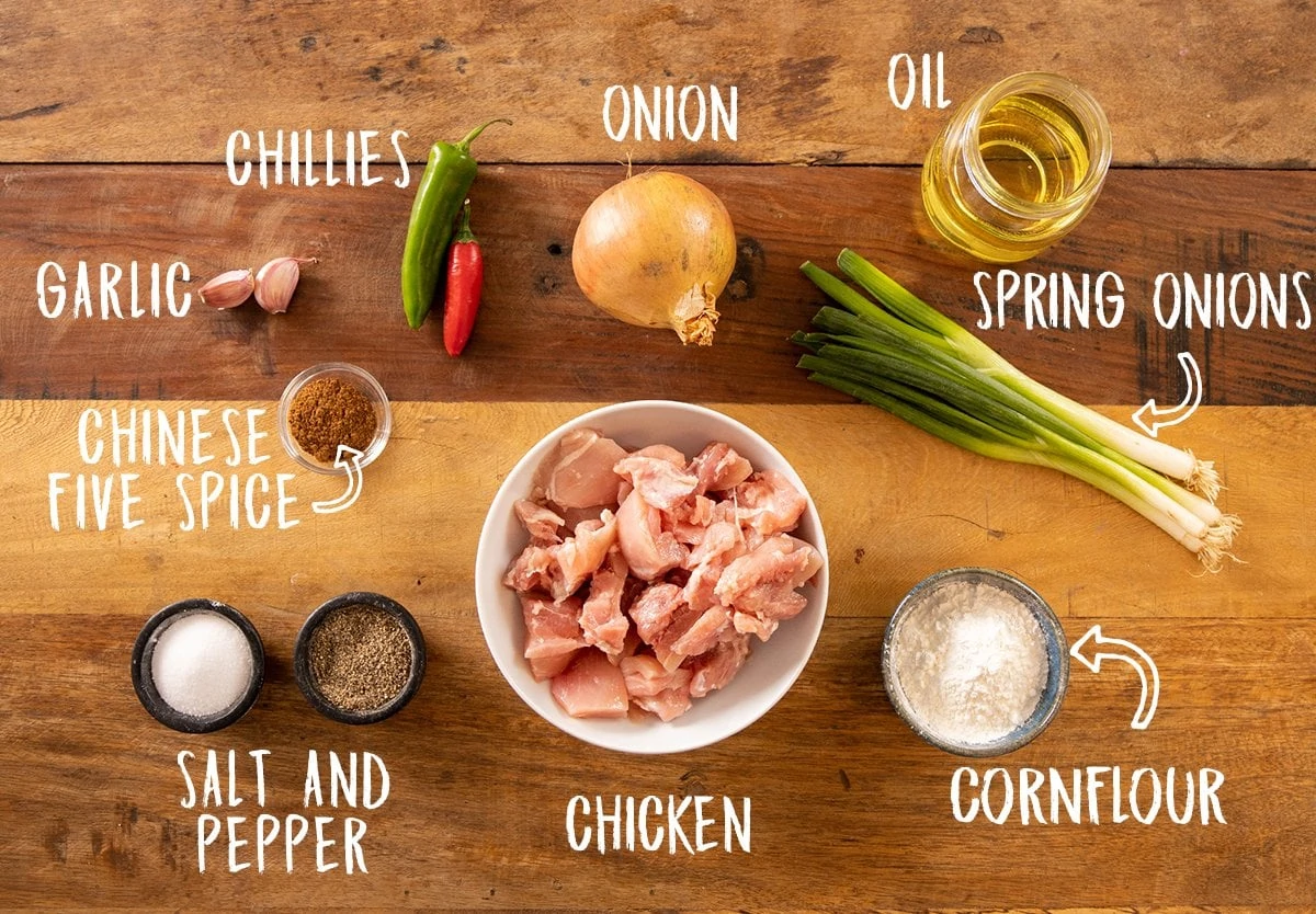 Ingredients for salt and pepper chicken on a wooden table