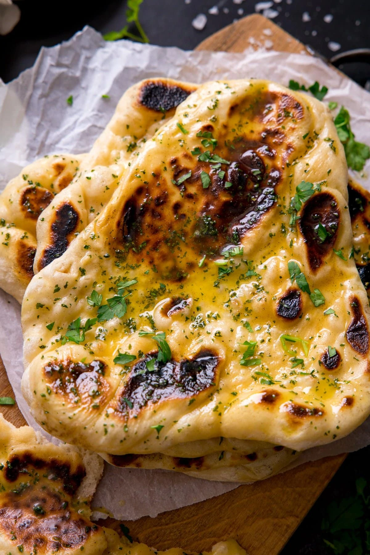 Overhead image of a pile of garlic naan breads.