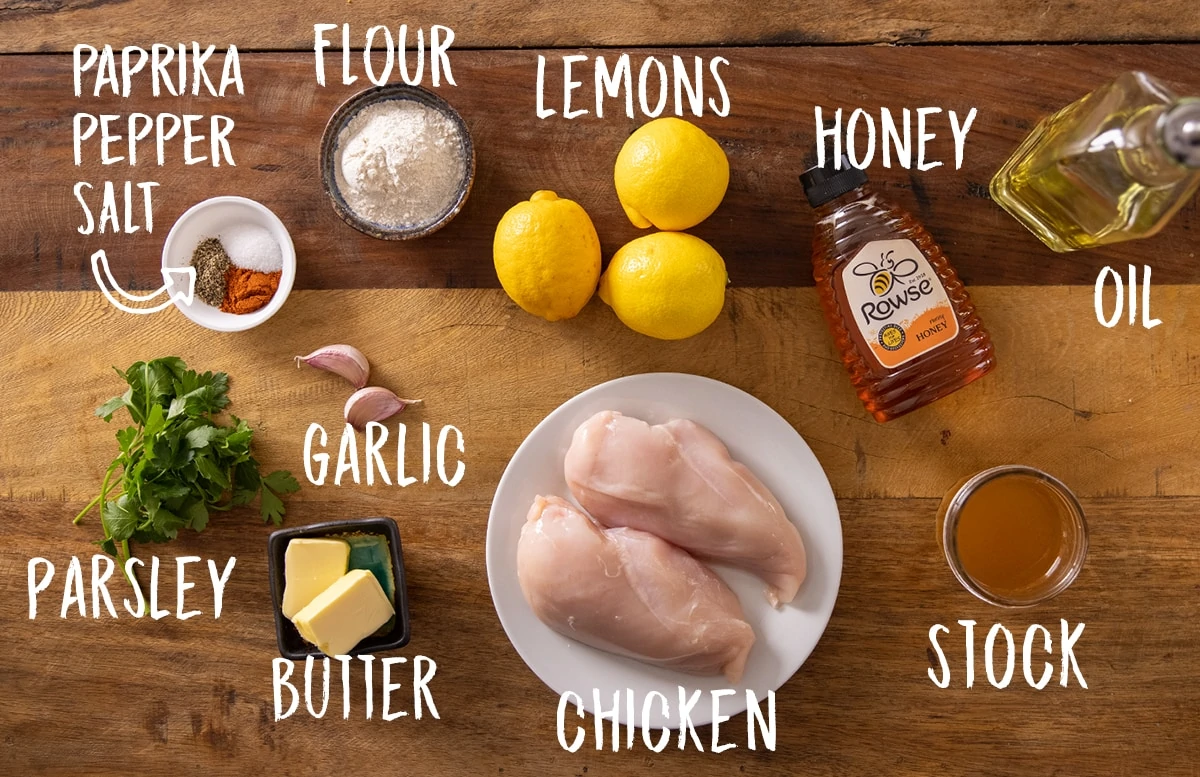 Ingredients for honey lemon chicken on a wooden table