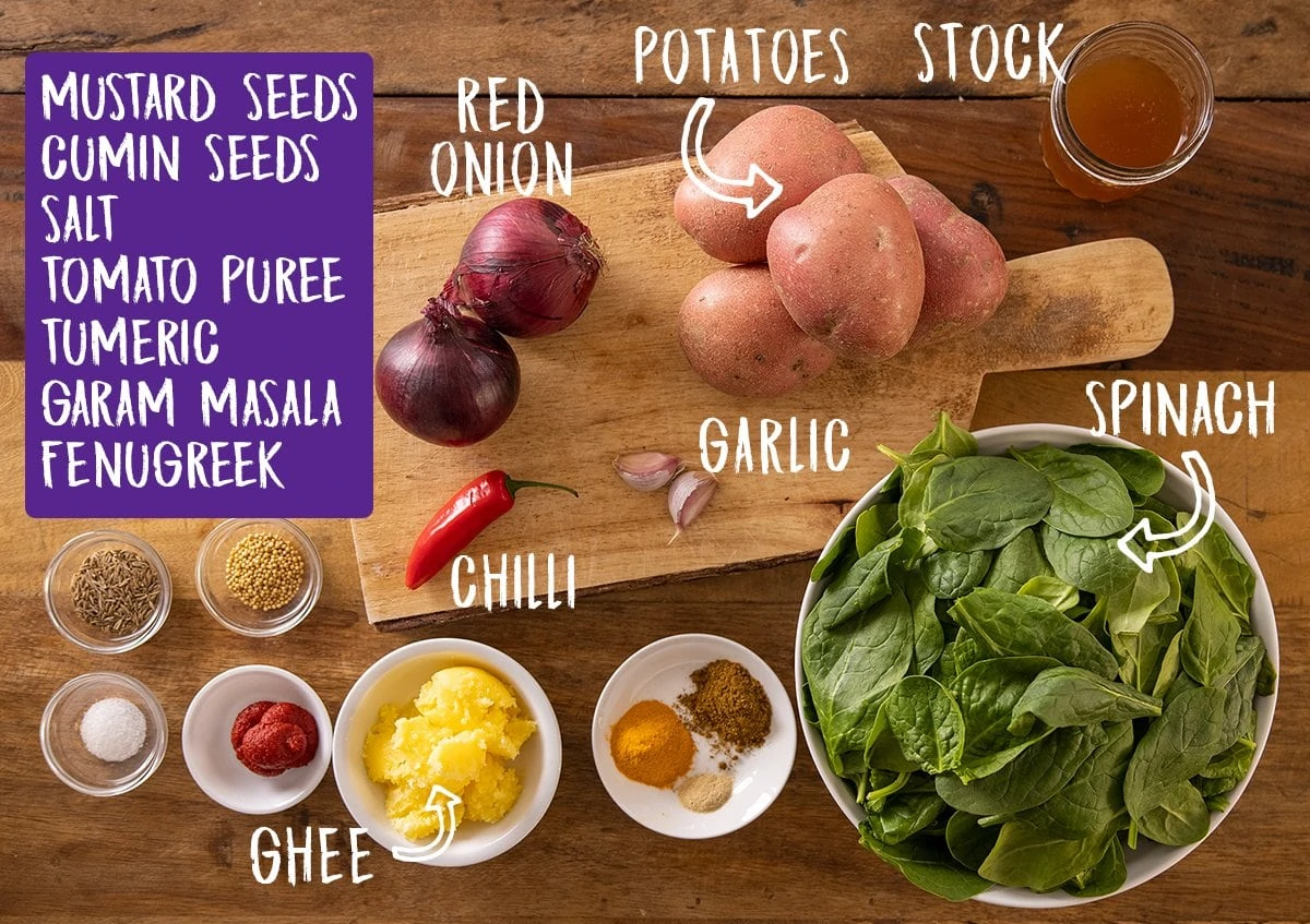 Ingredients for saag aloo on a wooden table