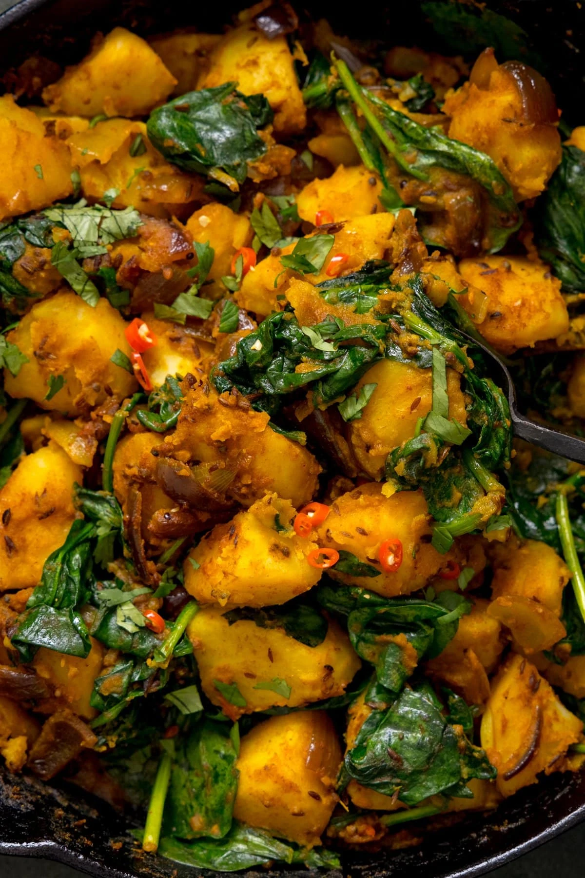 Close up image of a pan of saag aloo