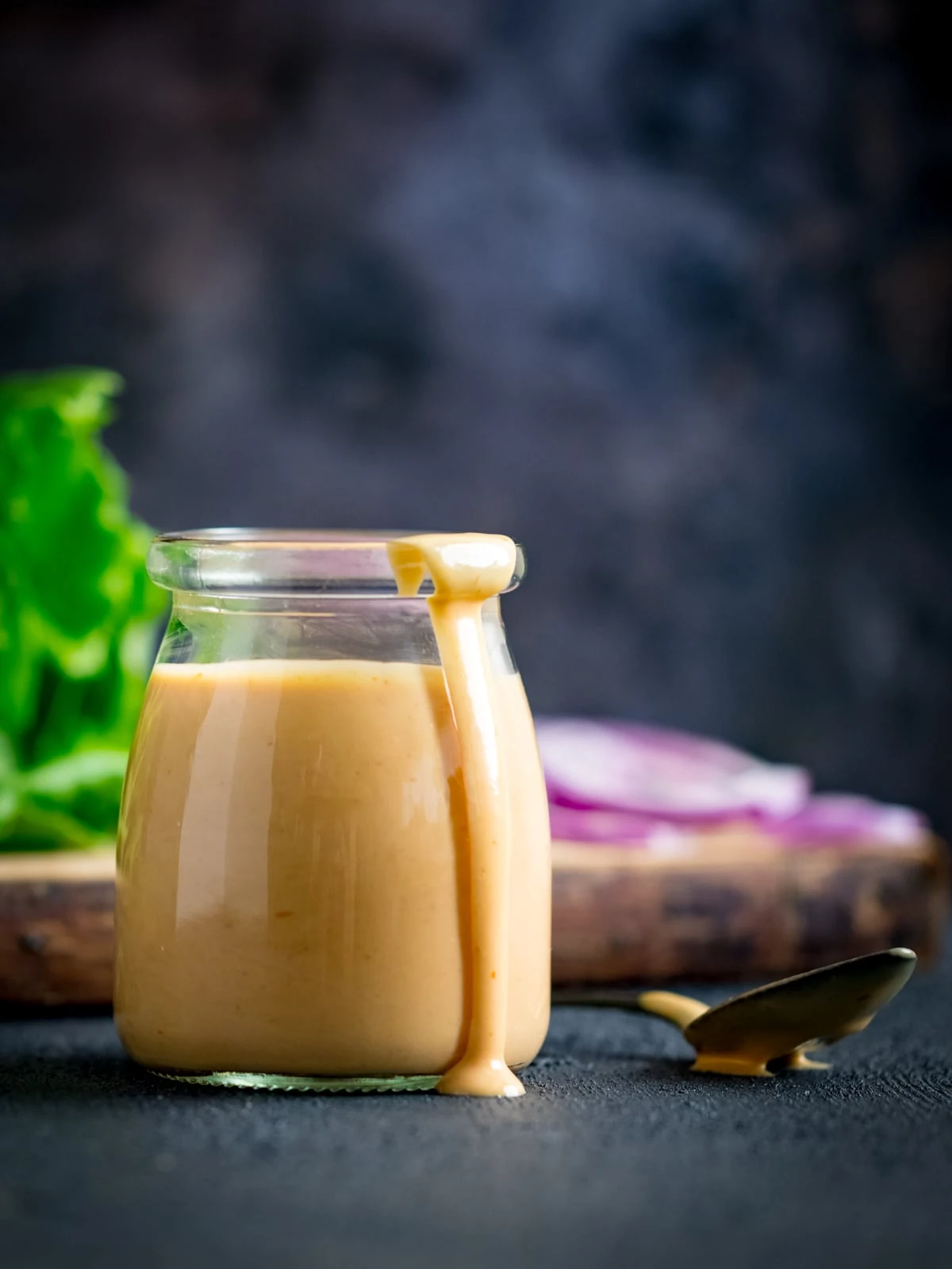 Burger sauce in a glass jar against a dark background