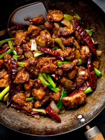 Szechuan chicken stir fry in a wok