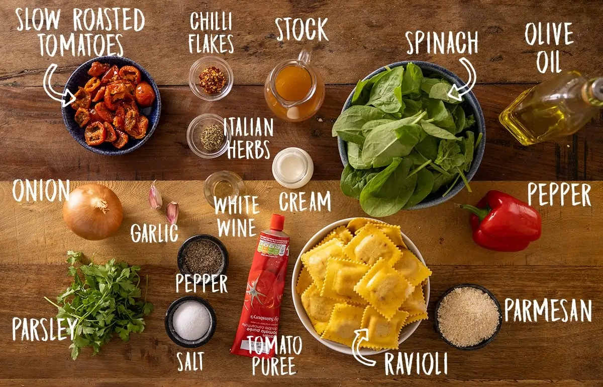 Ingredients for creamy tomato ravioli on a wooden table