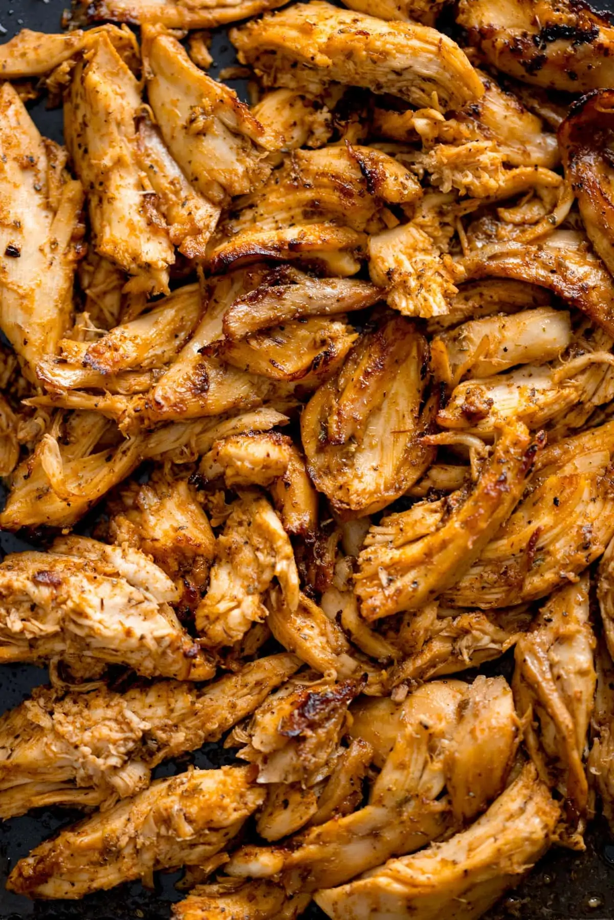Overhead shot of shredded, spiced, grilled chicken - ready for making chicken gyros.