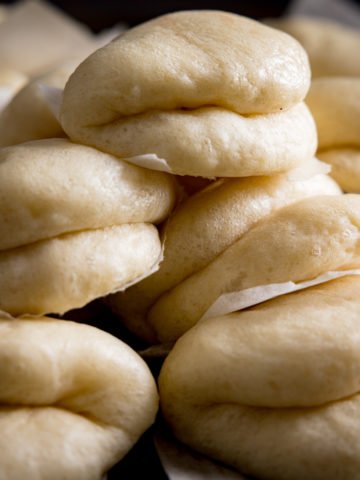 A close up of Lots of bao buns piled up high