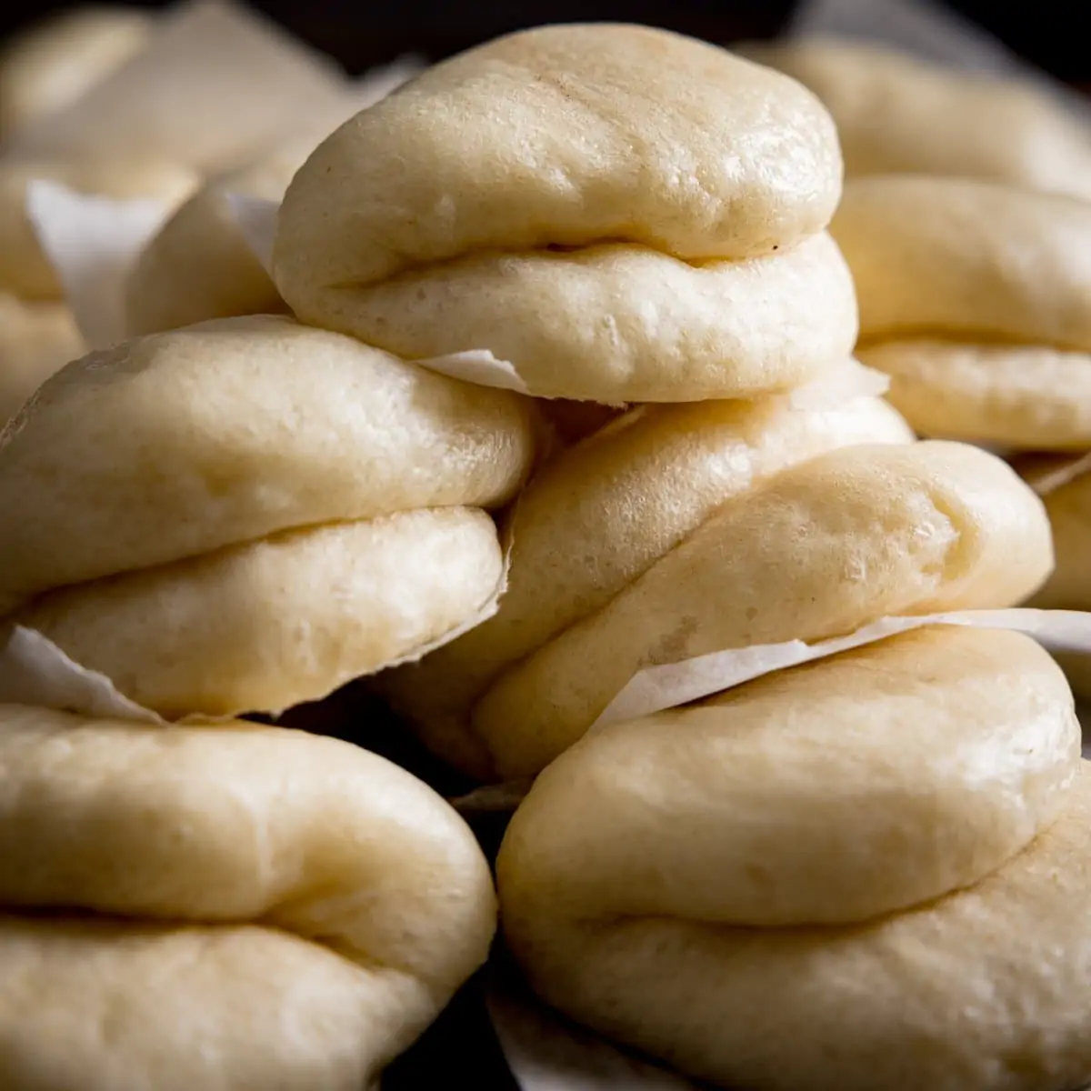 A close up of Lots of bao buns piled up high