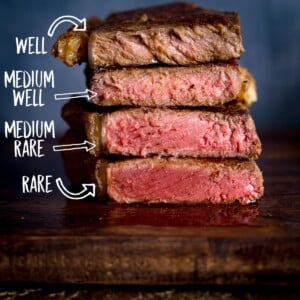 Square image of Four steaks on a wooden board, sliced open and piled on top of each other to show varying amounts of doneness. There is a label for each doneness level.