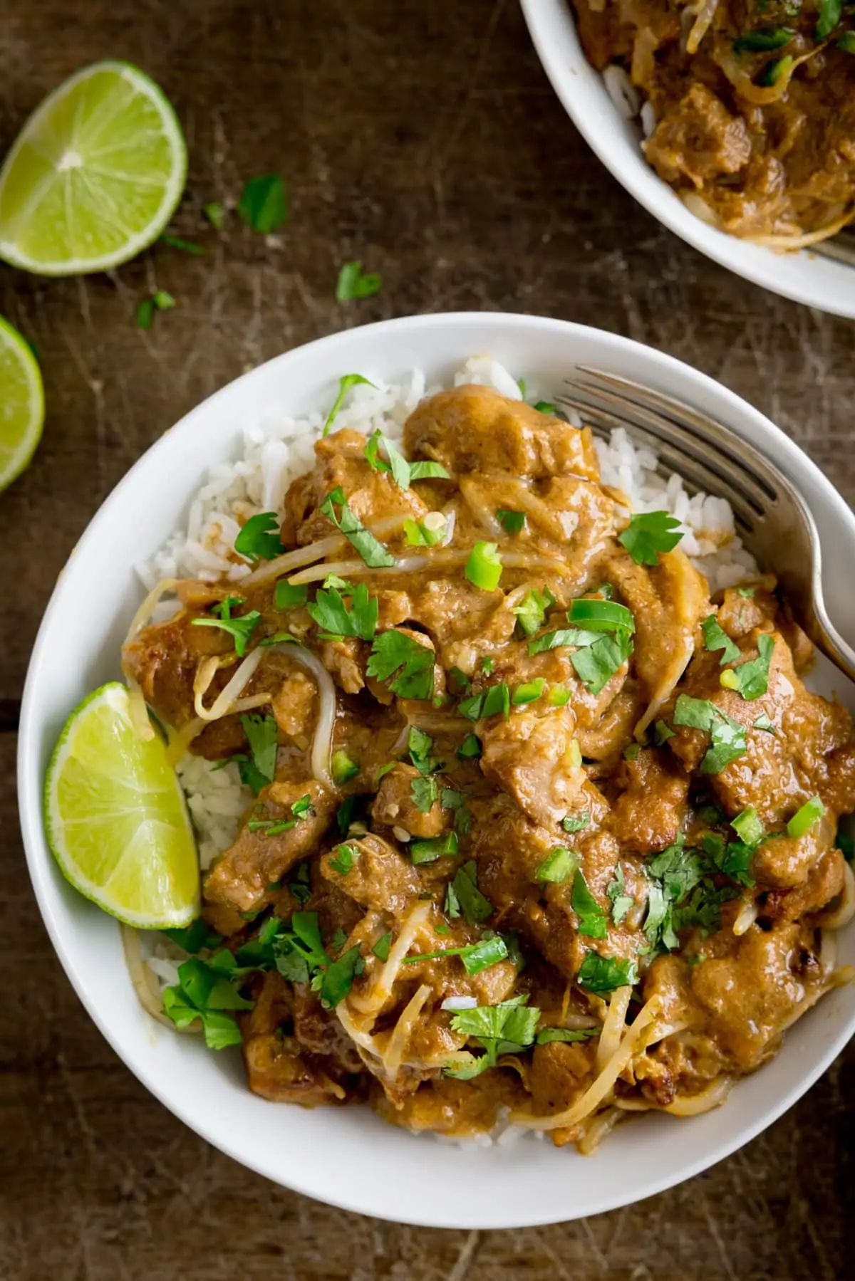 Close up overhead shot of Thai style peanut pork in a bowl with rice.