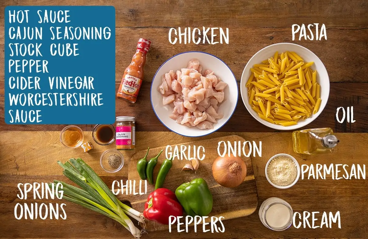 Ingredients for buffalo chicken pasta on a wooden table