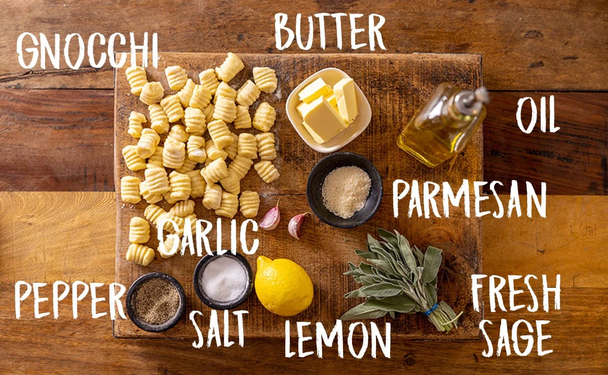 Ingredients for gnocchi with brown butter and sage on a wooden table.