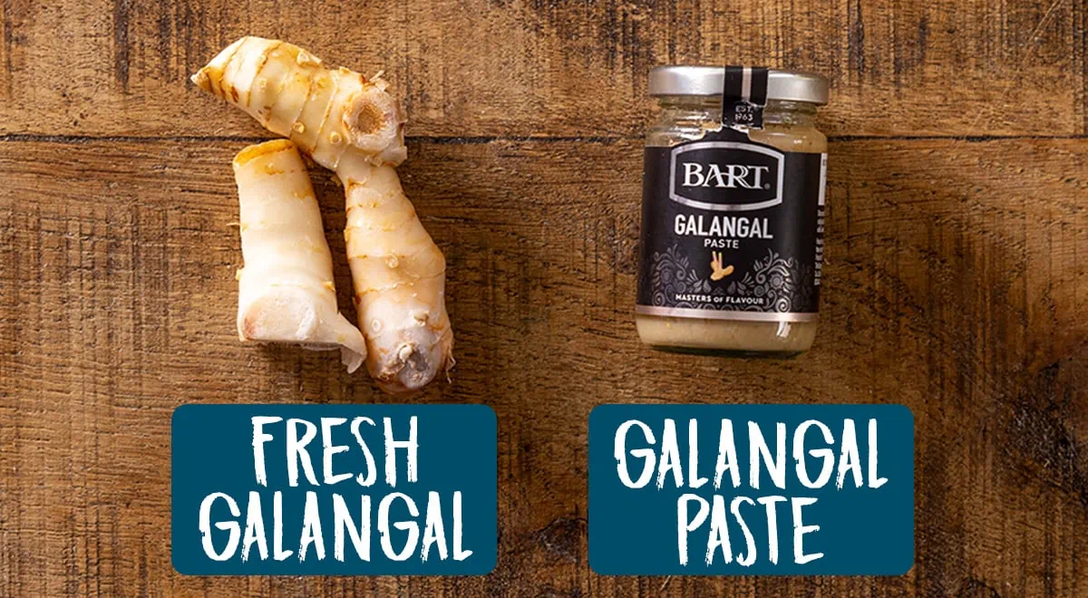 Fresh galangal and galangal paste on a board next to each other.