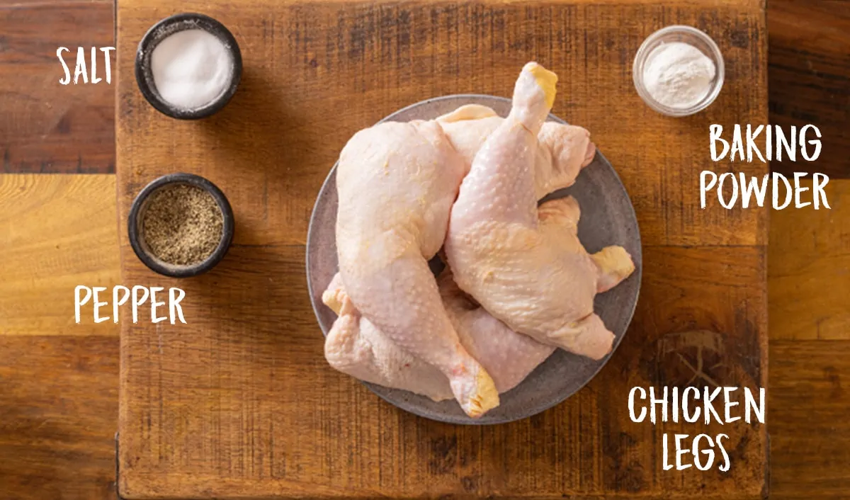 Ingredients for crispy air fryer chicken legs on a wooden table