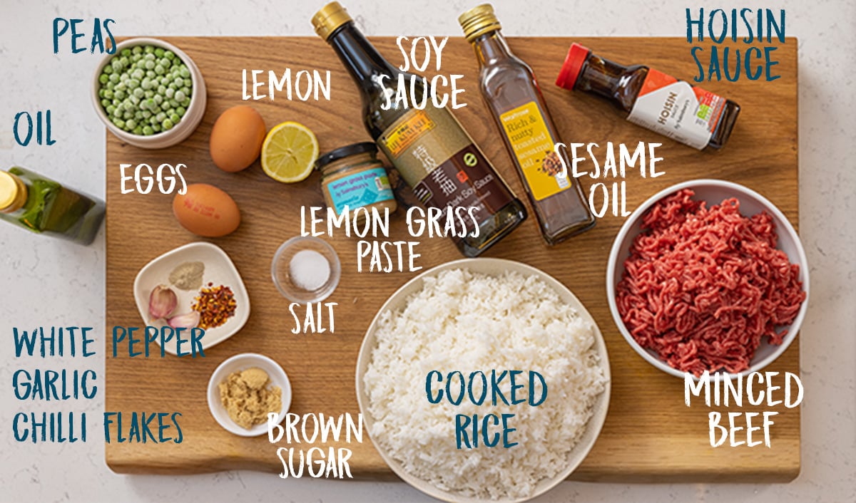 Ingredients for minced beef fried rice on a wooden board