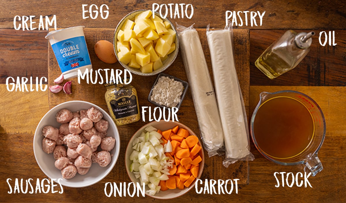 Ingredients for sausage and mustard pie on a wooden table