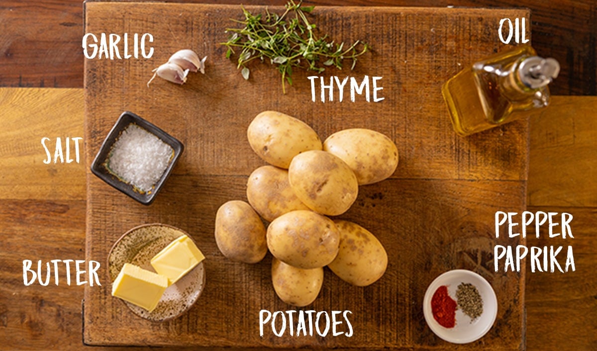 Ingredients for hasselback potatoes on a wooden table