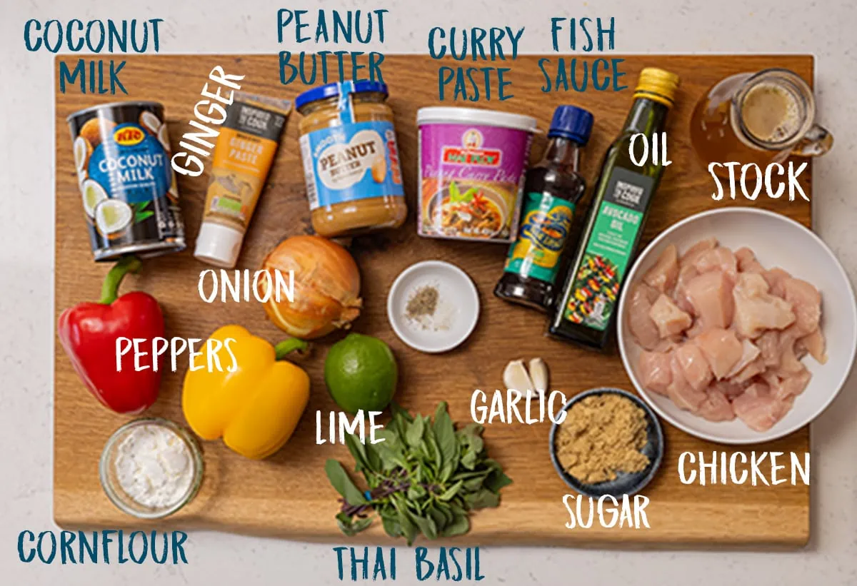 Ingredients for chicken panang curry on a wooden board