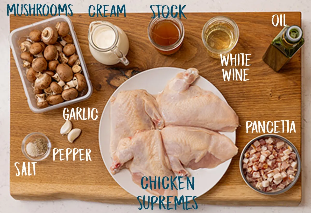 Ingredients for chicken supreme on a wooden board.